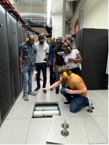 Photo: Fousseyni Kane and Mamadou Sangare (USTBB, Mali) and Fredrick Kakembo, Henry Mutegeki, and Olga Nsangi Tendo (Makerere University, Uganda) tour of the Center for High-Throughput Performance at the University of Wisconsin-Madison.