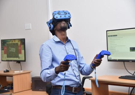 Rodgers Kimera demonstrates a VR set up at ACE-Uganda.